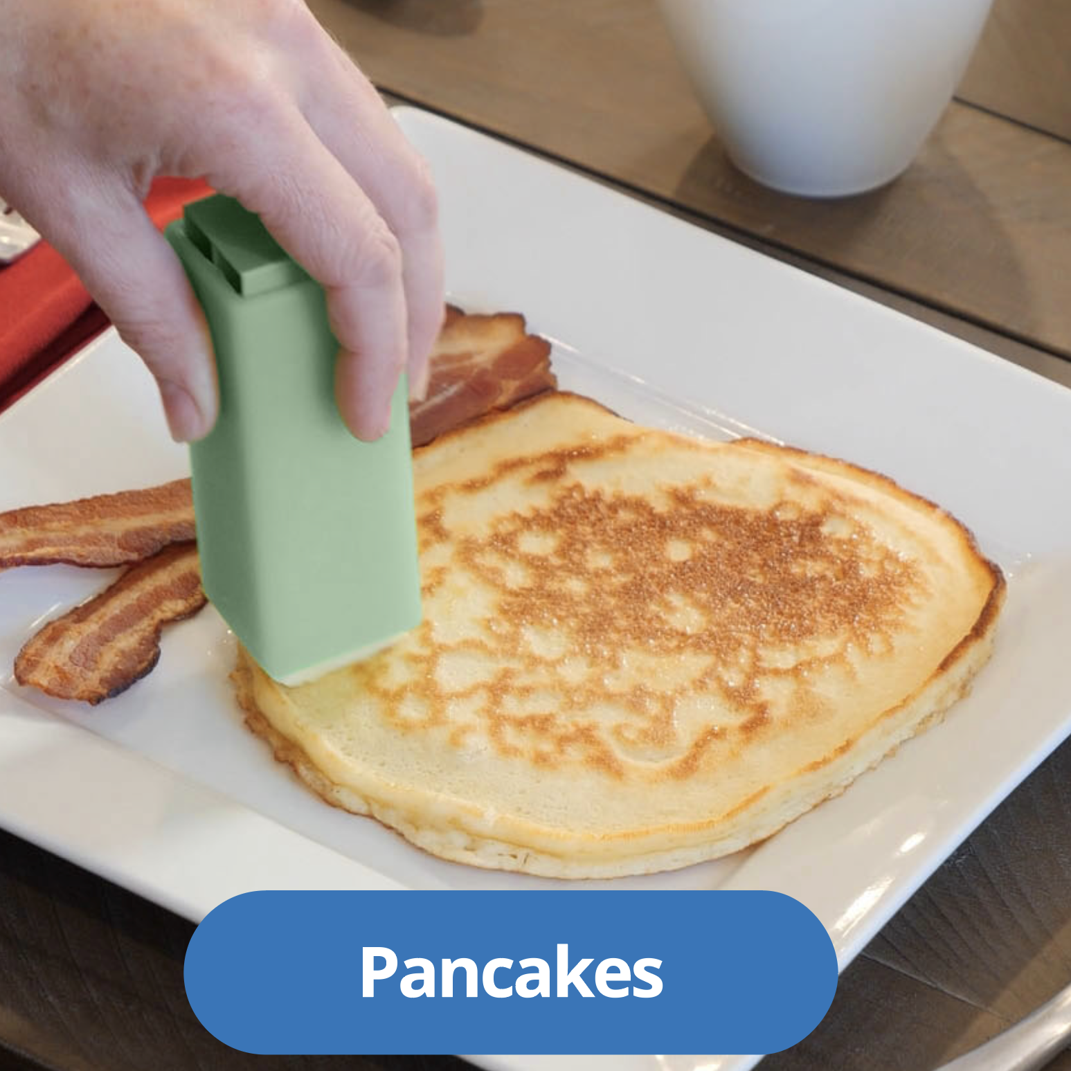 Gliding butter over a warm stack of pancakes with a Butter Crayon