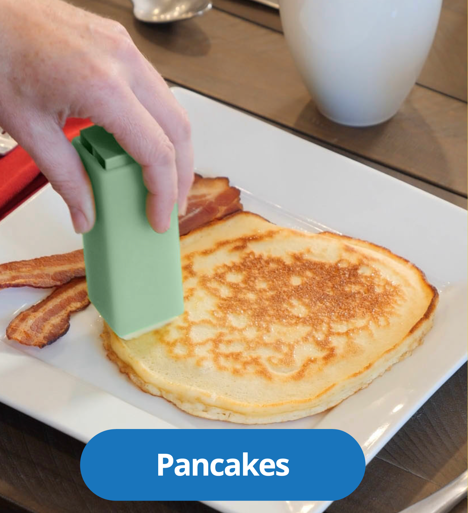 Gliding butter over a warm stack of pancakes with a Butter Crayon
