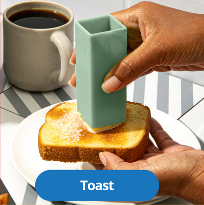 A Butter Crayon spreading a smooth, even layer of butter across a slice of toast